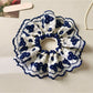 Close-up of Gifty artistic stylish scrunchie with colorful abstract pattern