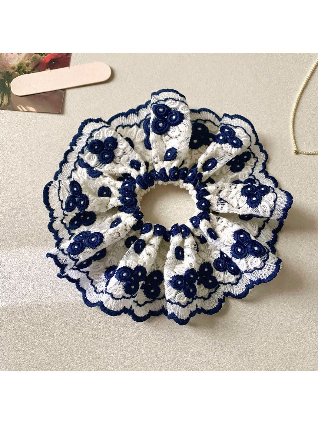 Close-up of Gifty artistic stylish scrunchie with colorful abstract pattern