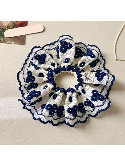 Close-up of Gifty artistic stylish scrunchie with colorful abstract pattern