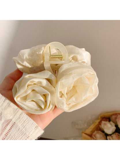 Side view of Beau elegant hair claw clip highlighting curved shape and rose embellishments