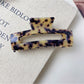 Beau minimalist claw clip displayed on a wooden surface with natural light