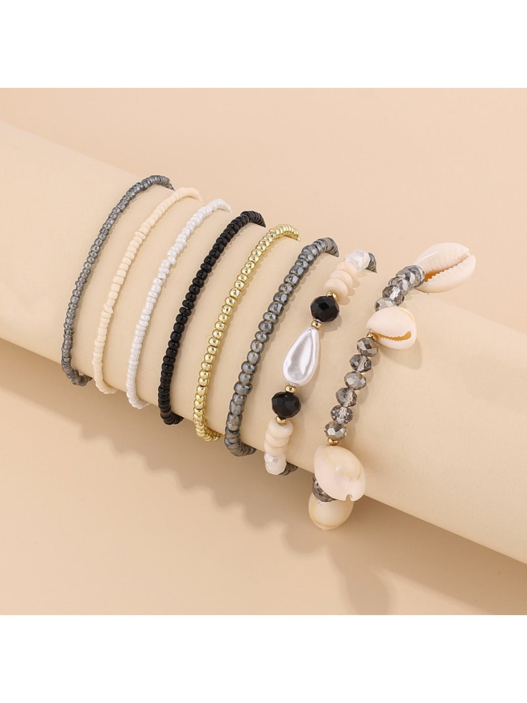 Lovra fashionable beaded bracelet with shell accents on a white background