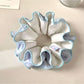 Close-up of Gifty ruched scrunchie showing fabric texture and color block design