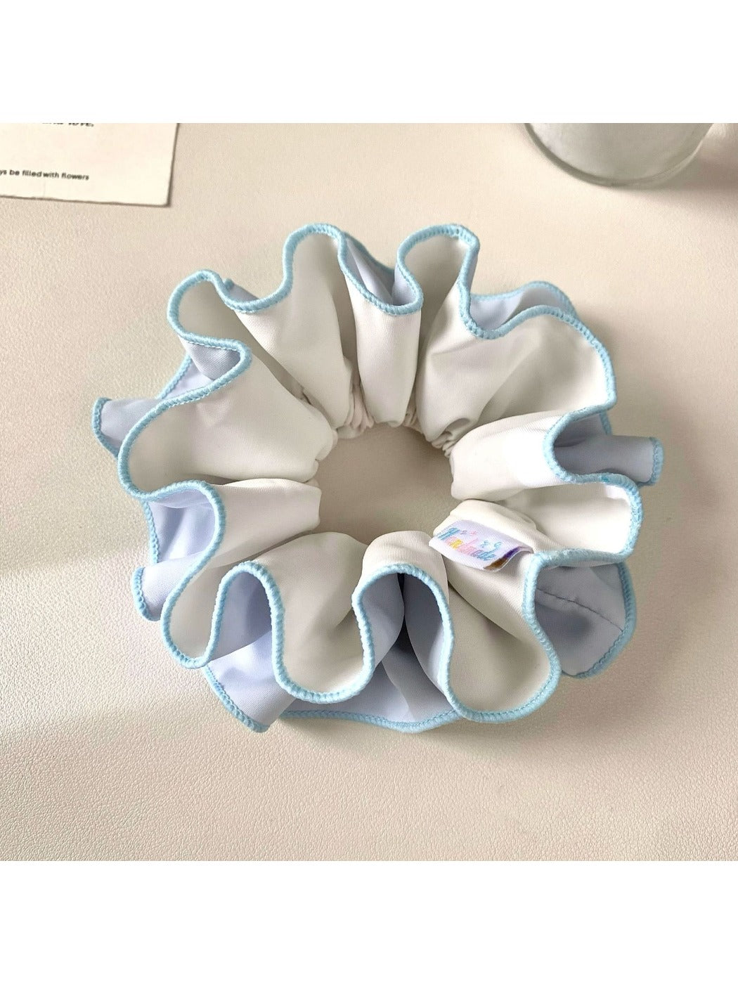 Close-up of Gifty ruched scrunchie showing fabric texture and color block design