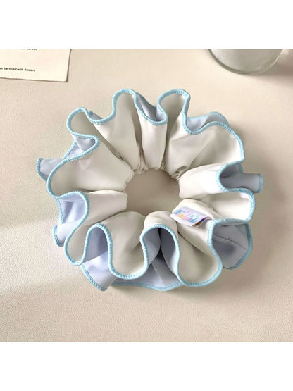 Close-up of Gifty ruched scrunchie showing fabric texture and color block design