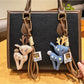 Close-up of Keypus cute deer charm keychain with brown and white enamel finish