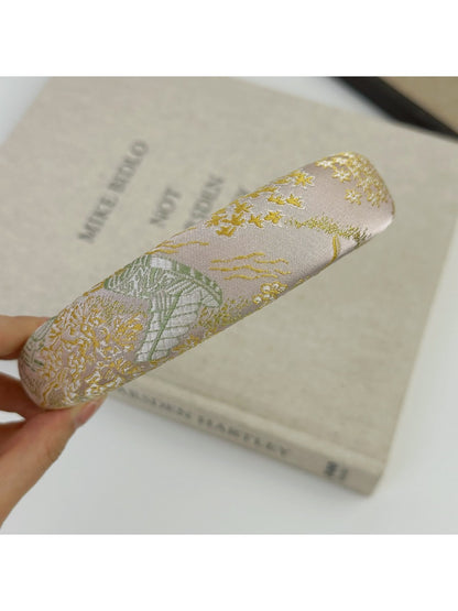Detailed view of fabric texture and embroidery on Gifty flower headband