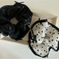 Model wearing Gifty bow tulle scrunchie styled in a ponytail with soft lighting