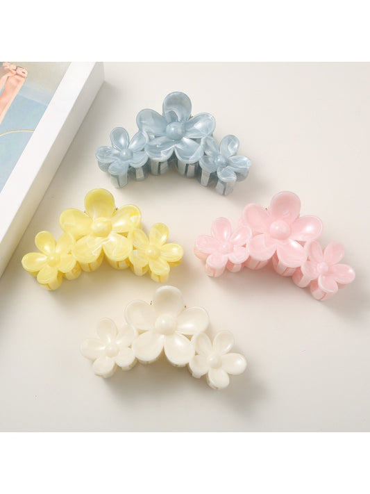Bright flower-shaped hair clip with yellow petals and a central pearl detail