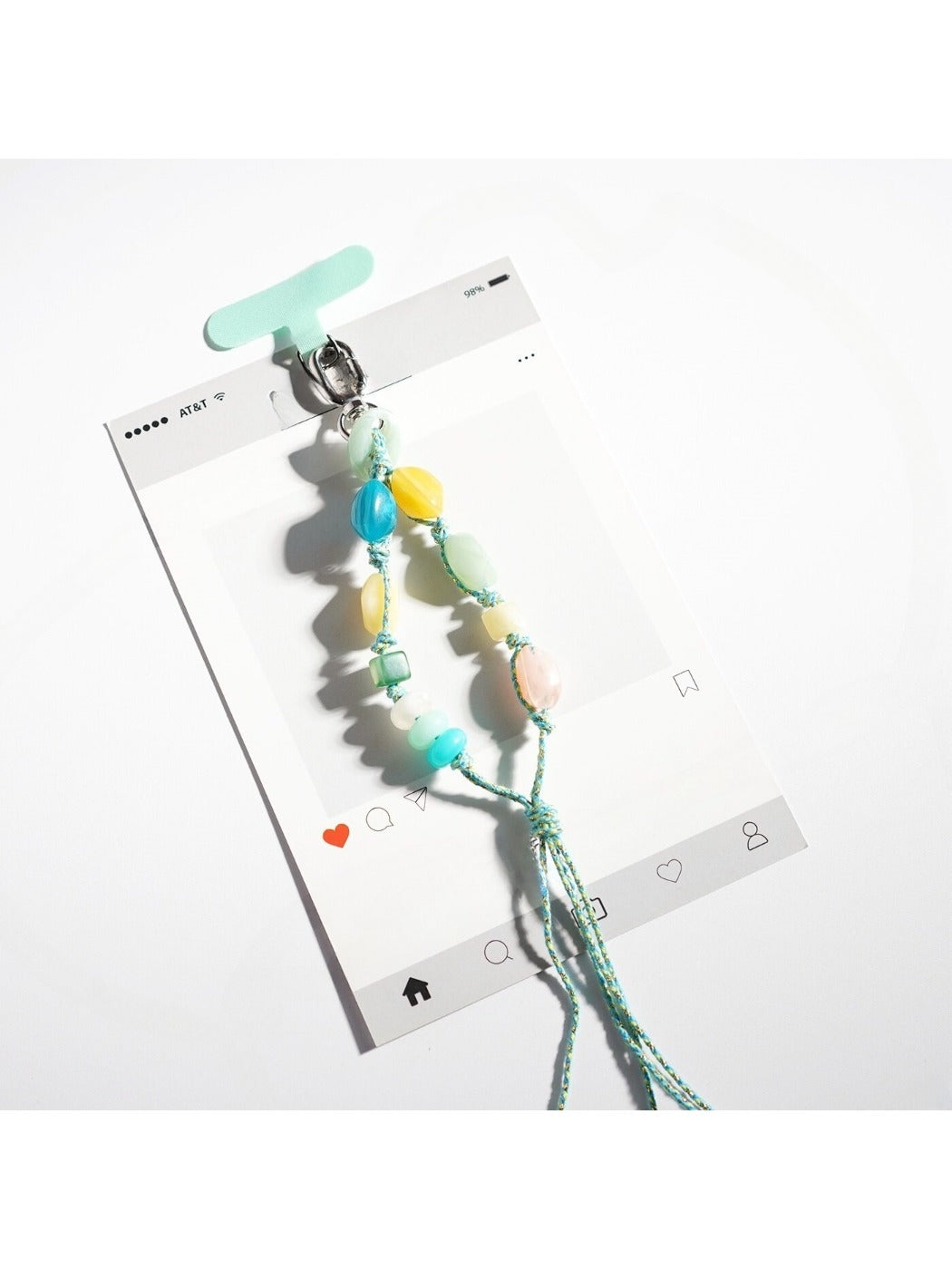 Resin bead keychain displayed on a wooden surface with natural light