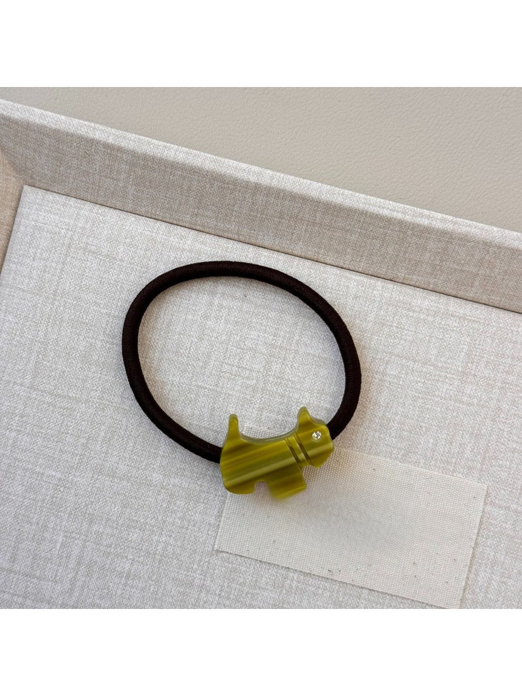 Gifty cartoon puppy hair tie displayed alongside matching accessories
