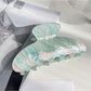Beau claw clip displayed with soft lighting to enhance pearlescent effect