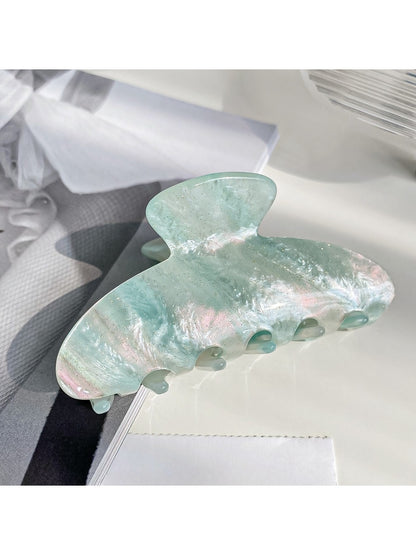 Beau claw clip displayed with soft lighting to enhance pearlescent effect