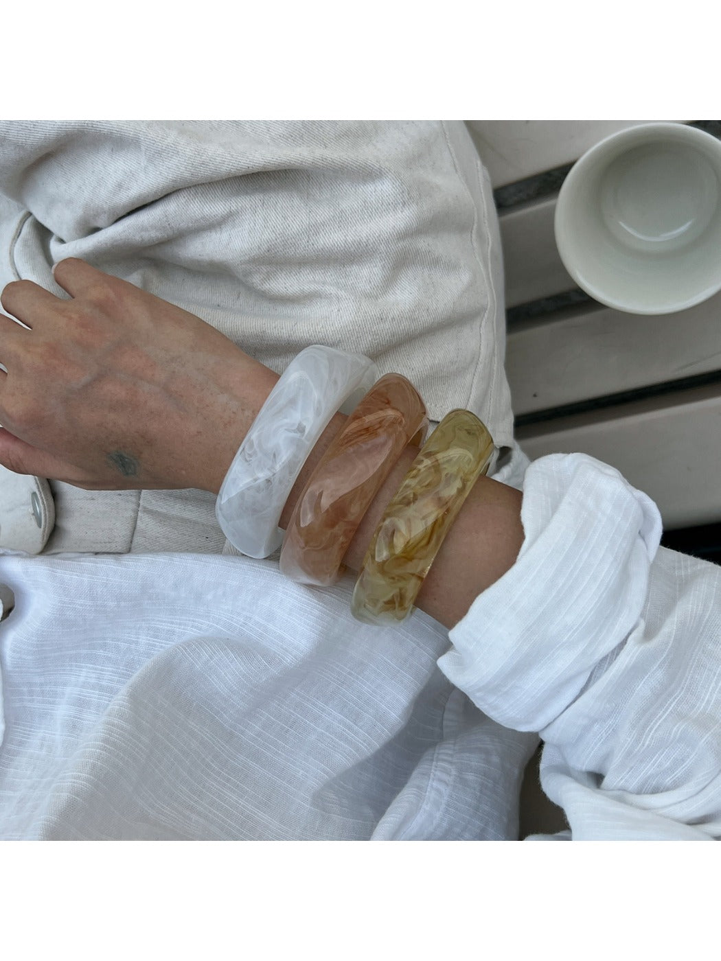 Side view of Lovra irregular shaped bangle bracelet emphasizing its thickness and curves
