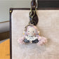 Detailed shot of the keyring and clasp mechanism of the vintage girl charm keychain