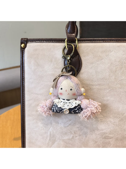 Detailed shot of the keyring and clasp mechanism of the vintage girl charm keychain