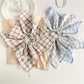 Close-up of red and black plaid lace bow on scrunchie