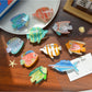 Beau tropical fish shaped hair clip made of translucent acetate with orange and yellow hues