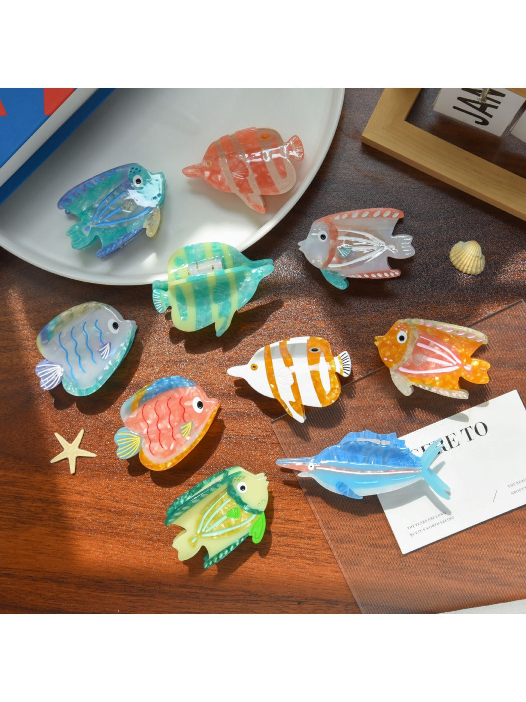 Beau tropical fish shaped hair clip made of translucent acetate with orange and yellow hues