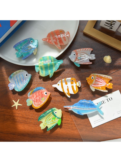 Beau tropical fish shaped hair clip made of translucent acetate with orange and yellow hues
