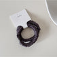 Model with long hair wearing Gifty satin hair tie styled in a low bun