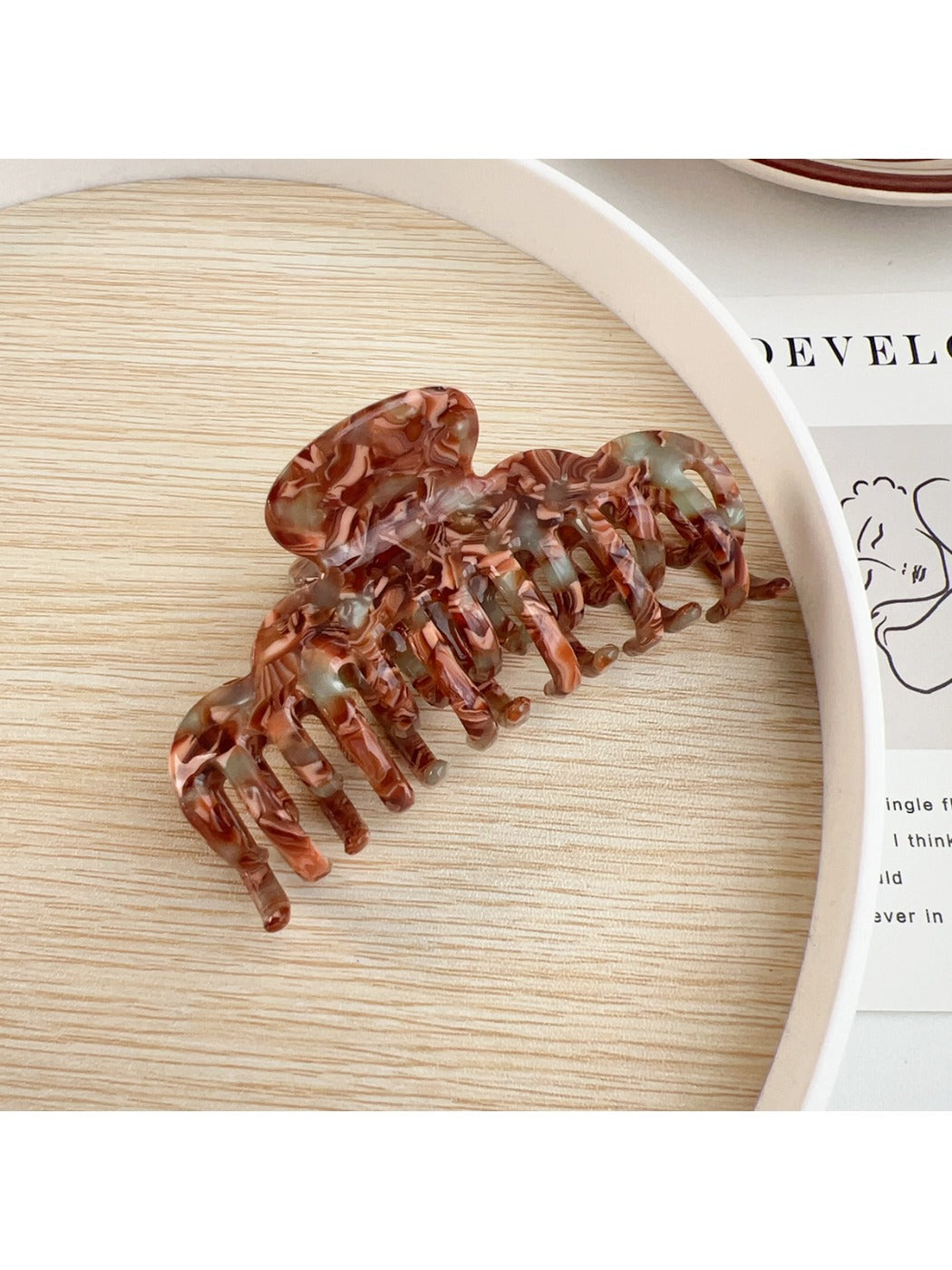 Beau claw clip worn in medium-length hair styled in a half-updo
