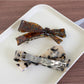 Close-up of Beau bow-shaped hair clip showing acetate texture and glossy finish