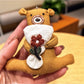 Bear keychain hanging from a set of keys with a blurred background