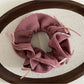 Gifty scrunchie packaged in clear box with branding visible on white background