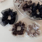Close-up of glossy scrunchie fabric showing its silky finish