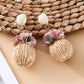 Model wearing Earedge fabric flower raffia ball earrings with casual outfit
