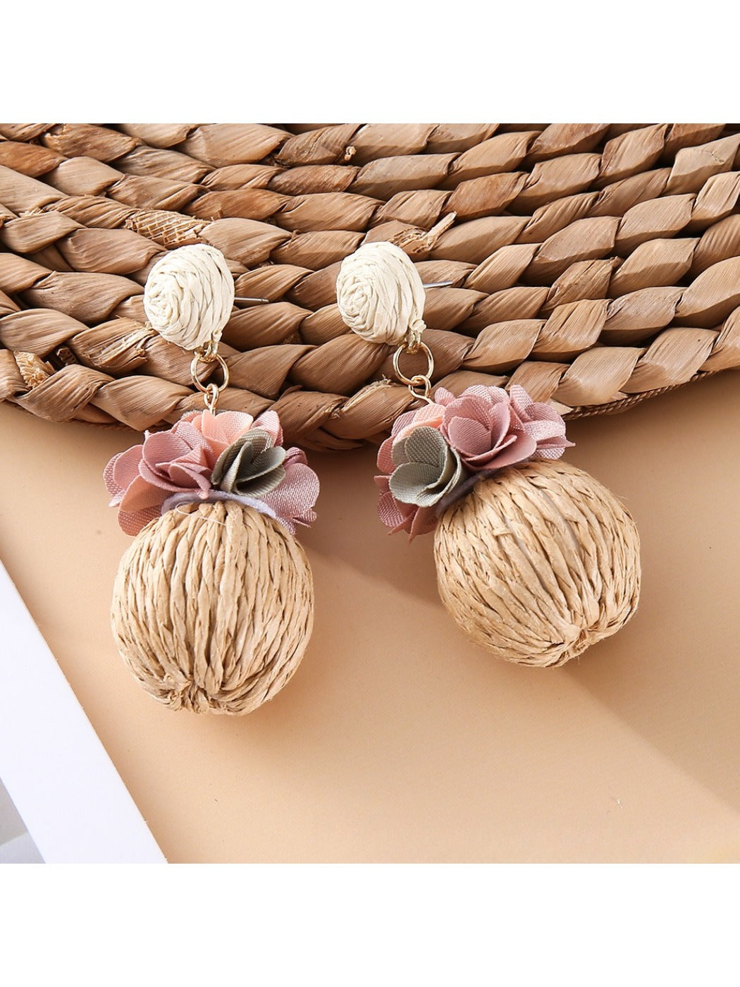 Model wearing Earedge fabric flower raffia ball earrings with casual outfit