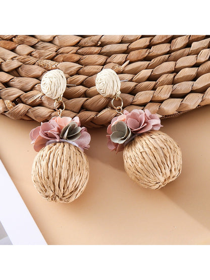 Model wearing Earedge fabric flower raffia ball earrings with casual outfit