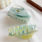 Side view of Beau hair claw clip highlighting clasp mechanism and cloud print