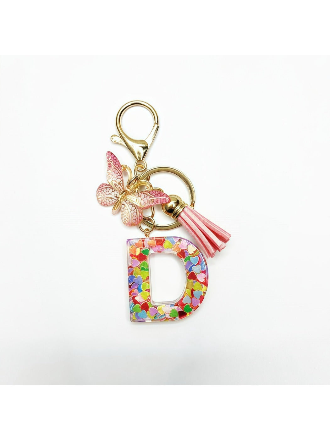 Letter pendant with butterfly charm on a silver keyring on a marble surface