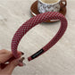 Gifty chic minimalist plaid headband folded to show inner lining and stitching