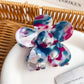 Colorful flower-shaped hair claw clip displayed against a neutral background