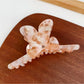 Beau hair claw clip holding thick hair in a half-up hairstyle