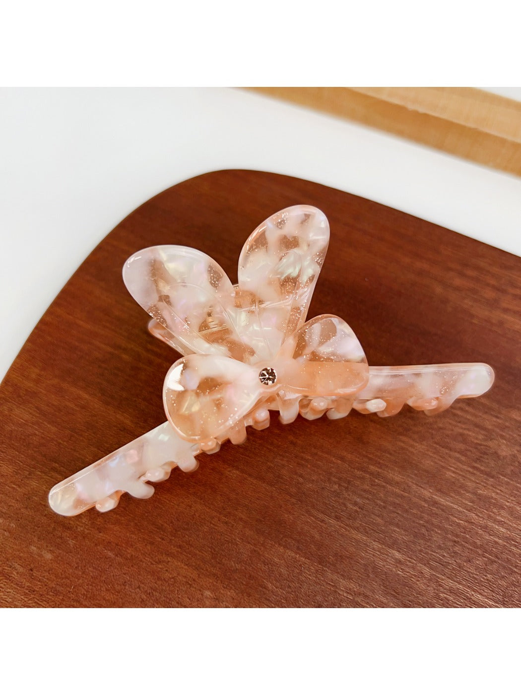 Beau hair claw clip holding thick hair in a half-up hairstyle