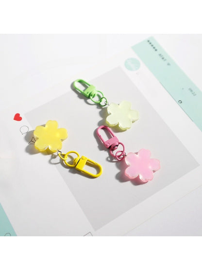 Close-up of flower-shaped keychain showing detailed petals and keyring