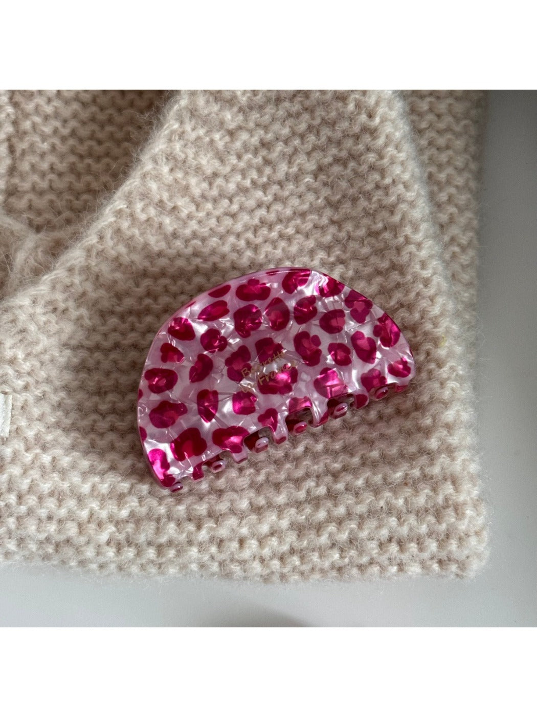 Beau pink leopard print acetate hair clip displayed on a flat surface