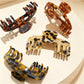 Close-up of Beau soft acetate claw clip showing curved teeth and hinge mechanism