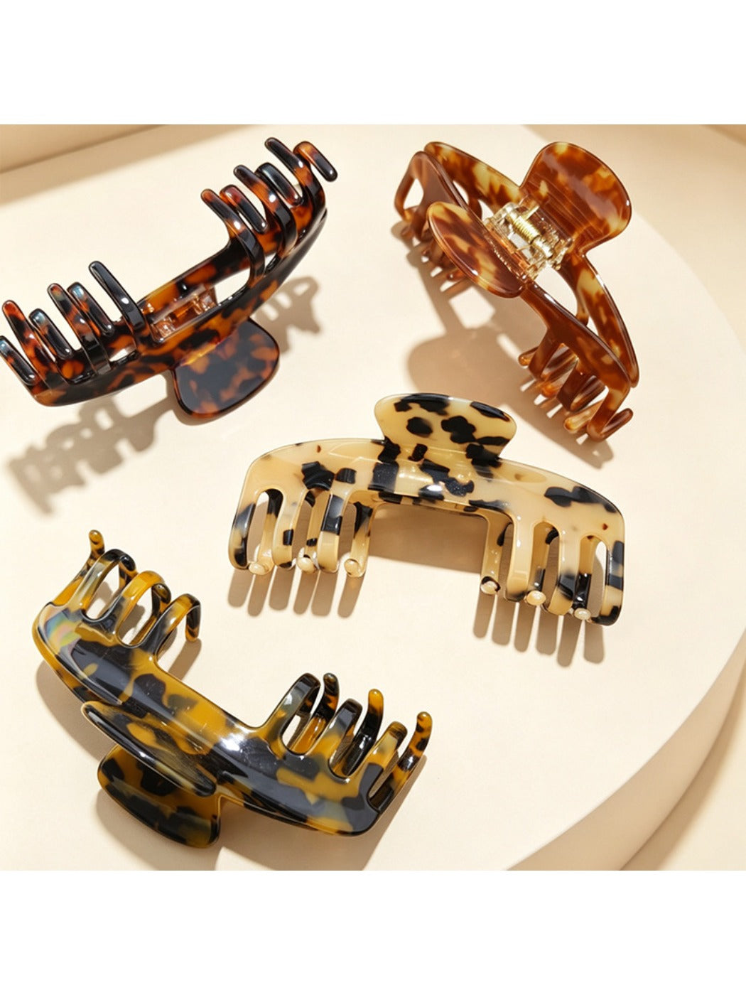 Close-up of Beau soft acetate claw clip showing curved teeth and hinge mechanism