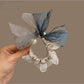 Hair tie with large bow detail styled on a model's ponytail
