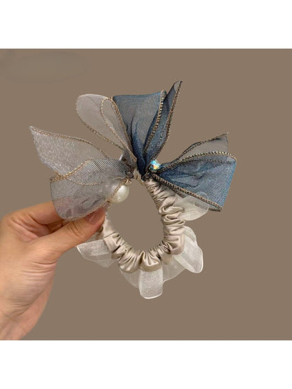Hair tie with large bow detail styled on a model's ponytail