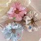 Close-up of Gifty striped scrunchie showing fabric texture and elastic band