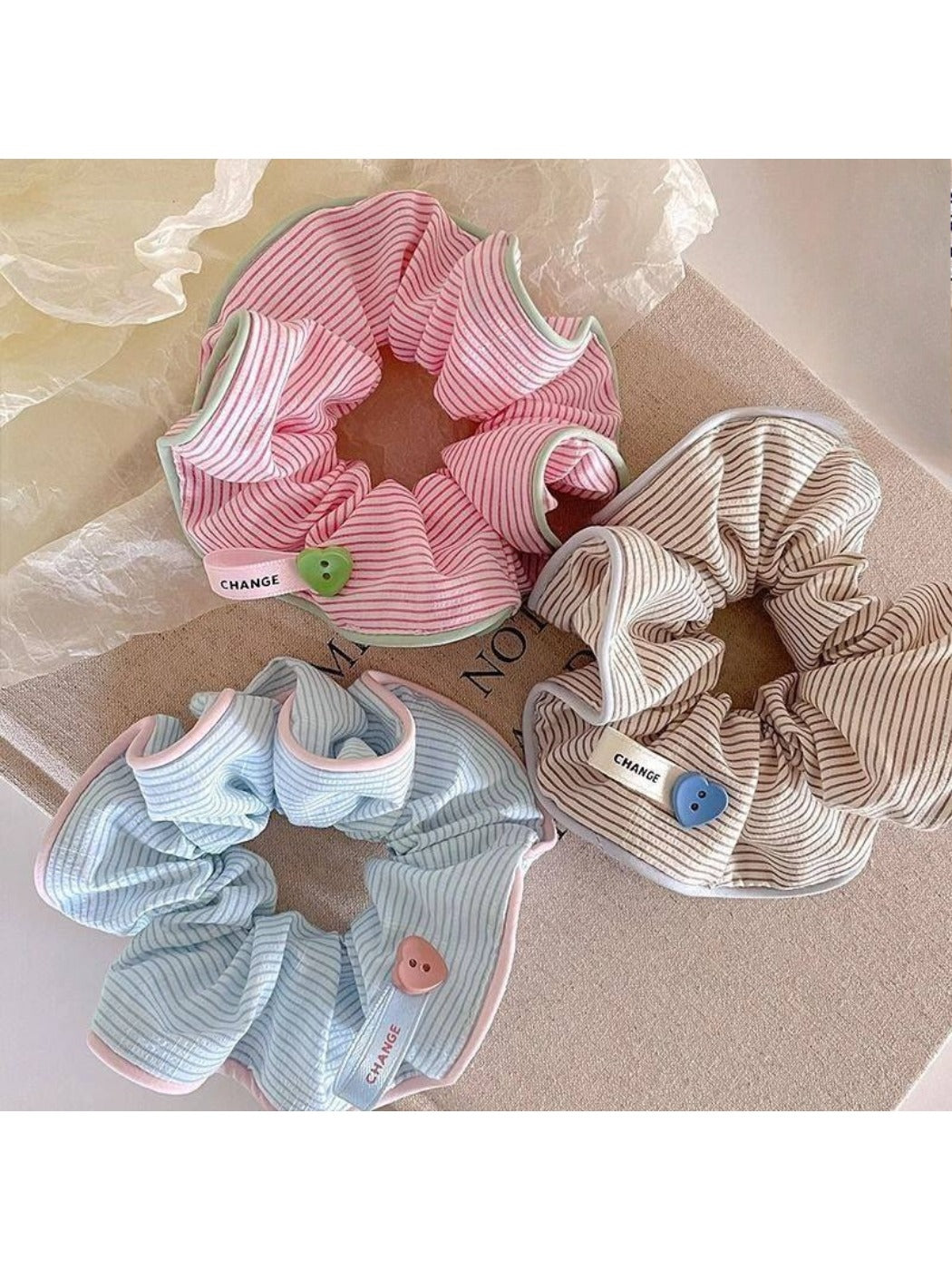 Close-up of Gifty striped scrunchie showing fabric texture and elastic band