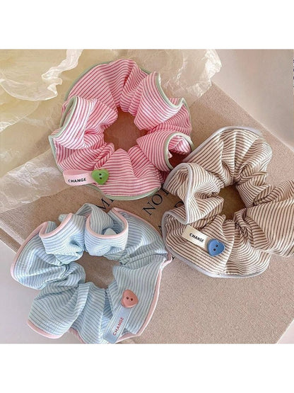 Close-up of Gifty striped scrunchie showing fabric texture and elastic band