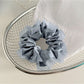 Side view of Gifty satin tulle scrunchie with ruffle trim