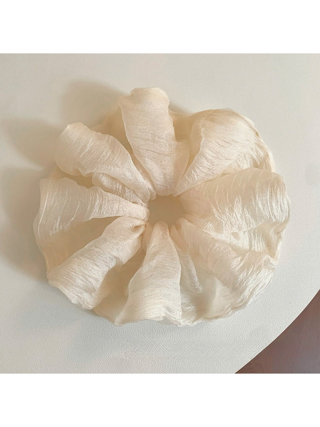 Close-up of a minimalist thin solid color scrunchie in soft fabric